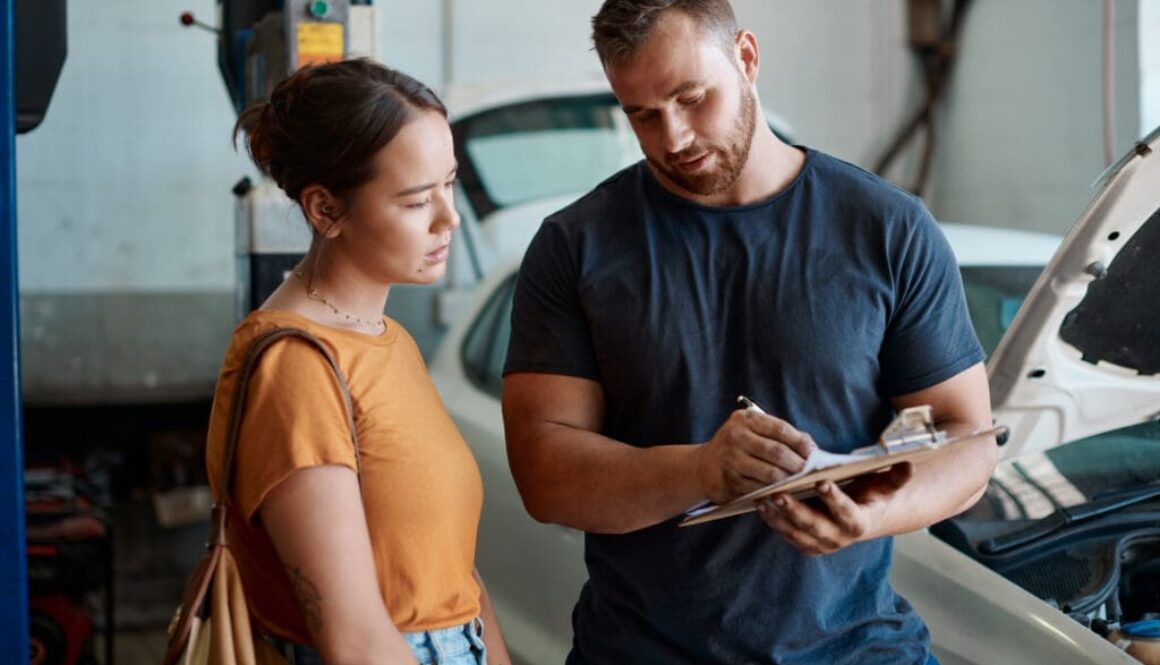 Woman, mechanic and sign document in auto repair shop, invoice and service for car maintenance. Female person, clipboard and customer for vehicle transaction, contract and garage workshop for quote
